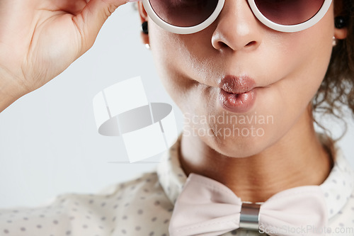Image of Sunglasses, fashion and face of woman with kiss pose on white background for summer, casual and trendy style. Creative, beauty and zoom of girl isolated in studio for cosmetics, makeup and confidence