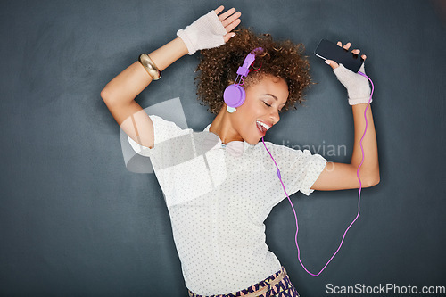 Image of Phone music, dancing singer and black woman listening to song, audio podcast or radio sound for energy, relief or fun. Studio singing, dancer or retro dance student isolated on chalkboard background