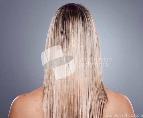 Image of Hair care, blonde woman and back view of natural beauty, keratin texture and beauty salon cosmetics on studio background. Model, long hairstyle and scalp treatment for shine, glow and healthy shampoo