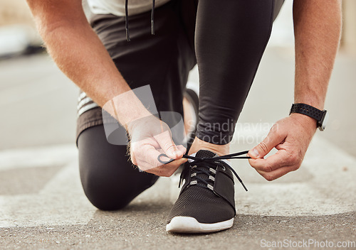 Image of Training, fitness or hands tie shoes to start cardio workout or sports exercise on ground or city road. Legs, runner or healthy sports man with running shoes or footwear laces ready for body goals