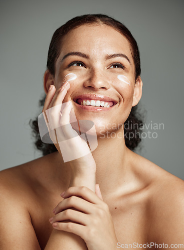 Image of Skincare, beauty and dermatology woman with cream for acne, health and glow on a studio background. Spa, sunscreen and model thinking of a cosmetics product for anti aging and facial wellness