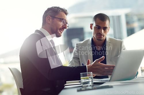 Image of Business people, laptop and talking about planning online for corporate strategy or partnership. Men together in a meeting discussion while speaking about internet report, email or communication