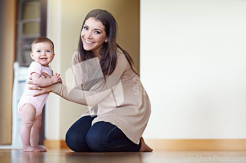 Image of Mother, family and baby for learning to walk for development and growth with help and support. Portrait of woman and child in house to play with love, security and care with a smile while walking