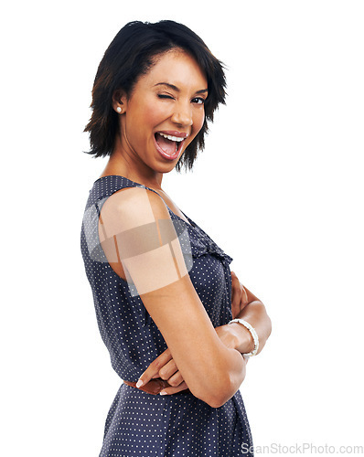 Image of Portrait, wink and mockup with a model black woman arms crossed in studio isolated on a white background. Marketing, advertising and branding with a young female flirting on blank mock up space