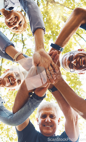 Image of Senior hands, together and support with solidarity outdoor and group diversity with team building in nature. Trust, respect and mission, mature community and hand stack low angle with collaboration.