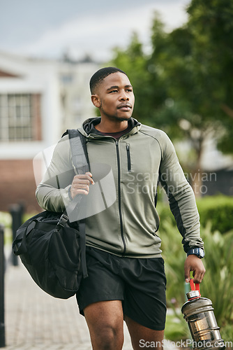 Image of Exercise, black man and walking with water bottle, for training and workout for wellness, fitness and health. African American male, athlete or bodybuilder ready for practice, motivation or hydration