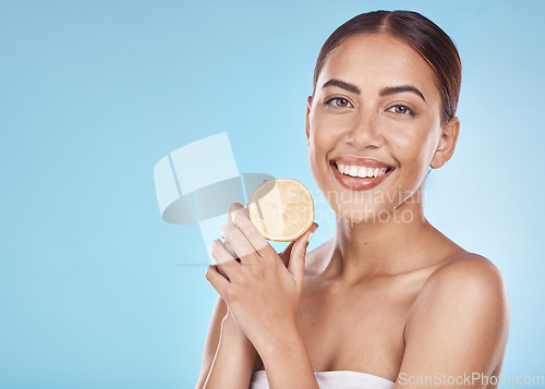 Image of Wellness, facial and lemon portrait of girl with natural smile and healthy glow for marketing. Beauty, skincare and self care model with fruit for cosmetic advertising in blue studio mockup.