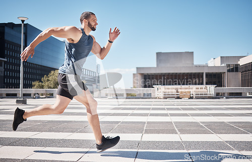 Image of Fitness, exercise and man running in city for health and wellness. Sports runner, energy and male athlete exercising, cardio jog or training workout outdoors on street for race, marathon or endurance