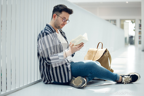 Image of Man, student and reading with glasses and book for knowledge, education or learning at university. Male learner in library with books for thesis, project or assignment for scholarship at the campus