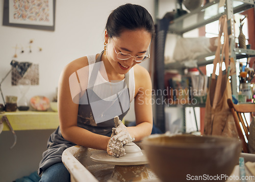 Image of Clay, sculpture or creative woman in workshop working on an artistic cup or mug mold in small business. Smile, Asian girl or happy Japanese worker manufacturing pottery products as entrepreneur