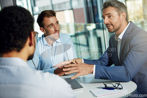 Image of Discussion, planning and business men in meeting for marketing strategy, ideas and work project. Teamwork, communication and group of male workers at desk talking, in conversation and brainstorming