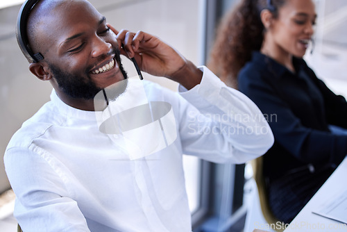 Image of Black man, face and smile with headset in call center, contact us with CRM and phone call with client. Communication, customer service with telemarketing and tech support, happy man on help desk