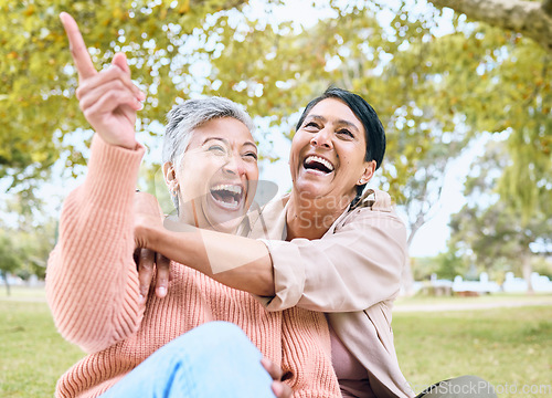 Image of Senior women, pointing or laughing in nature park, grass garden or relax environment in comic joke or funny meme. Smile, happy or couple of friends in retirement elderly bonding, hug or hand gesture
