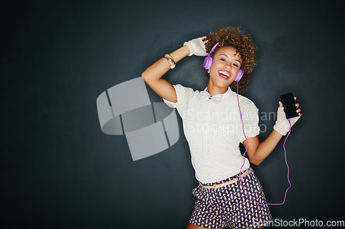 Image of Phone music, dance portrait and mock up black woman listening to song, audio podcast or radio sound with fun energy. Studio mockup, dancing girl and retro student isolated on dark background