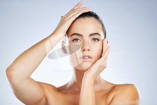 Image of Beauty, skincare cosmetics and portrait of a woman isolated on a grey studio background. Glow, clean and face of a spa dermatology model with facial health, hydration and wellness on a backdrop