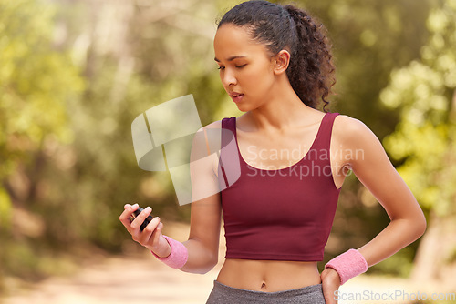 Image of Fitness, woman and checking stop watch for running exercise, workout or training in the nature outdoors. Active female runner looking at time for monitoring run, steps or cardio performance tracking