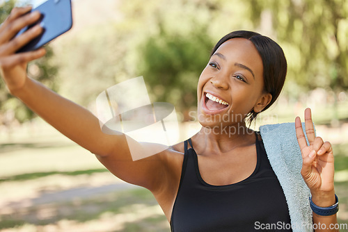 Image of Selfie, peace and park with a sports black woman taking a photograph outdoor during fitness or exercise. Social media, towel and nature with a female athlete posing for a picture while training