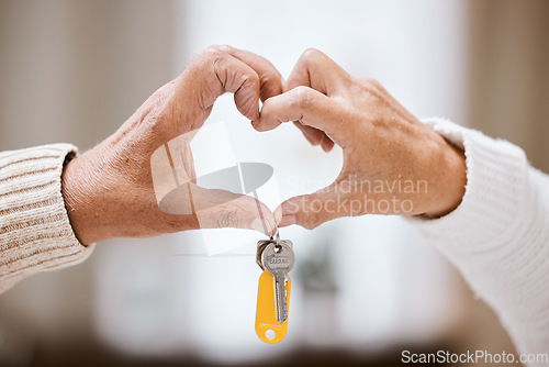 Image of Senior couple, heart hands and keys for new home, success and bonding with love, care and support. Closeup, elderly people and hand sign together in house, apartment or home with excited homeowner