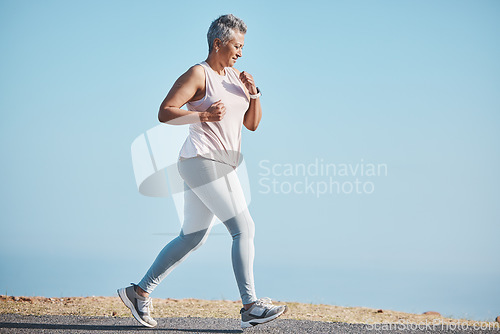 Image of Sports, nature and senior woman doing a running workout for health, wellness and exercise in Puerto Rico. Fitness, runner and elderly female cardio athlete at outdoor training for a marathon or race.