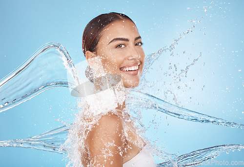 Image of Happy woman, body skincare or water splash on blue background studio in healthcare wellness, Brazil hygiene maintenance or shower grooming. Smile portrait, beauty model or wet water drop for cleaning