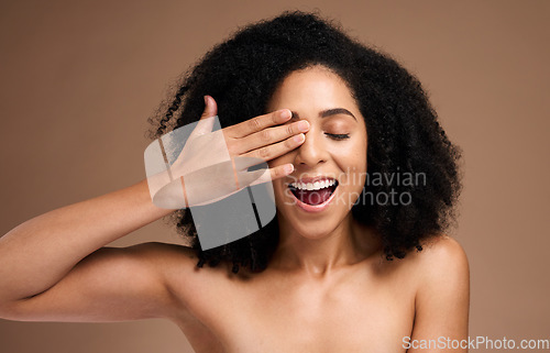 Image of Hand, face and surprise with black woman and beauty, hair care with shine and skincare with healthy skin glow. Natural curly hair, manicure and cosmetic care with facial against studio background