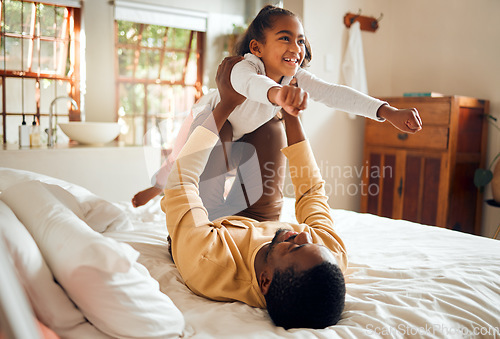 Image of Happy, fun and dad with child on bed playing, bonding and airplane game for father and daughter time in home. Family, love and playful energy, black man holding girl in air and laughing in bedroom.