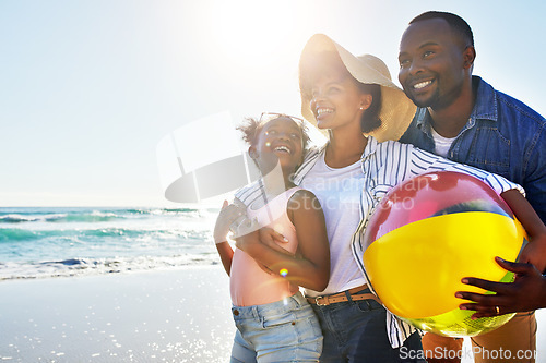 Image of Black family, kids or beach with a woman, man and girl child carrying a ball while walking on the sand by the sea. Love, nature and ocean with a father, mother and daughter on the coast in summer