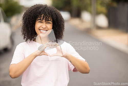 Image of Heart hands sign, black woman and portrait of a young person in a urban street showing love gesture. African female, happiness and smile with mock up space with hand making emoji shape outdoor