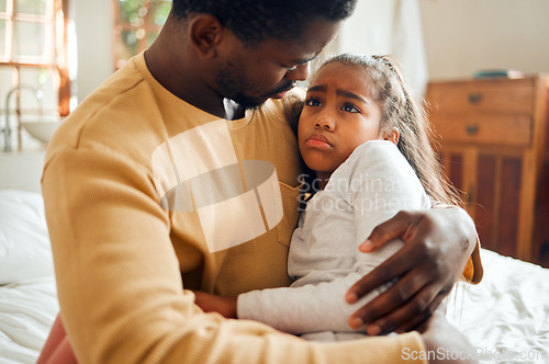 Image of Sick, sad and father holding his child with an illness, pain or problem in her bedroom at their home. Ill, care and African dad holding his girl kid with concern while she has the flu, cold or fever.