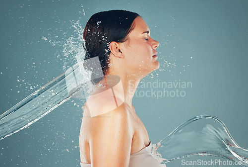 Image of Skin, water splash and skincare for woman hygiene and hydration isolated in a studio or shower background. Self care, grooming and female spa for beautiful, adult and wellness model