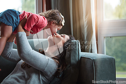 Image of Relax, happy and kiss with mother and baby on sofa for bonding, quality time and child development. Growth, support and trust with mom and daughter in family home for health, connection and care