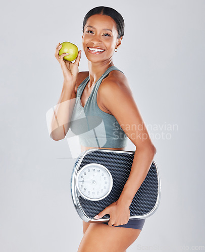 Image of Health, scale and portrait of woman with apple on diet for weight loss, workout and healthy lifestyle. Fitness, nutrition and body wellness, fit girl isolated on white background in studio with fruit