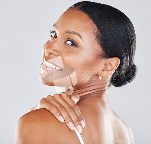 Image of Portrait, face and hand on shoulder with a model black woman in studio on a gray backgrouns for wellness. Health, luxury and beauty with an attractive young female posing to promote skincare