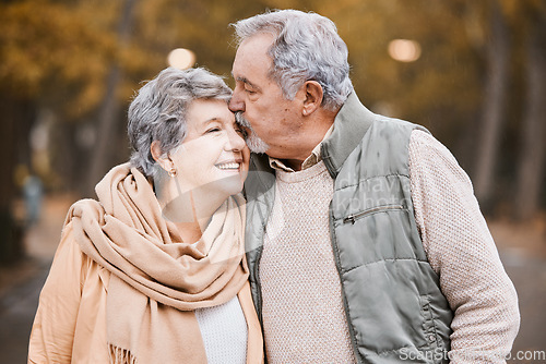 Image of Love, kiss and senior couple in park enjoying weekend, quality time and romantic bonding together. Retirement, relationship and elderly man and woman walking, hugging and embrace outdoors in nature