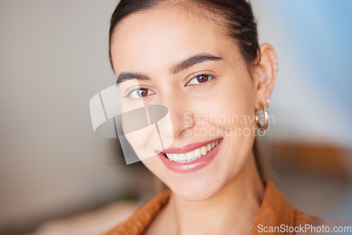 Image of Portrait, face and beauty with a woman, happy indoors with her cosmetic skincare products or routine. Teeth, makeup and smile with an attractive young female posing inside with natural glowing skin