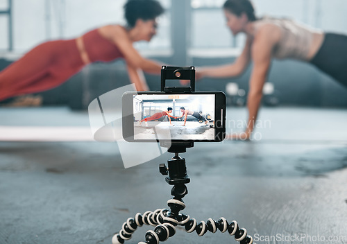 Image of Influencer, phone and fitness people recording, filming or broadcast online training video, exercise tutorial or guide. Sports, handshake and athlete team, women of friends live streaming gym workout