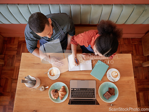 Image of Creative, writing and small business partnership in cafe for startup, brainstorm and planning by business people. Coffee shop, owners and man with woman for planning, vision and strategy in notebook