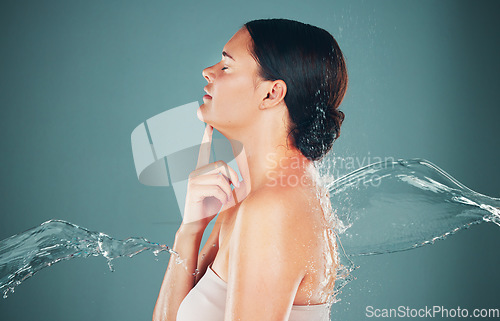 Image of Skincare, beauty and water splash on woman washing body for hygiene and hydration isolated in a studio background. Self care, grooming and female dermatology for young beautiful adult