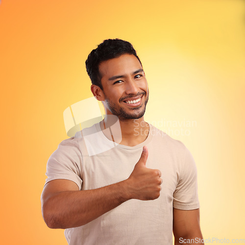 Image of Hands, thumbs up and portrait of man in studio isolated on a yellow background. Face, fashion and happy male model with hand gesture for like emoji, motivation or success, agreement or thank you.