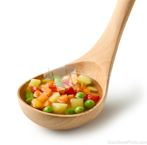Image of vegetable soup in wooden ladle