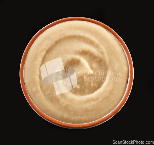 Image of hummus on black background