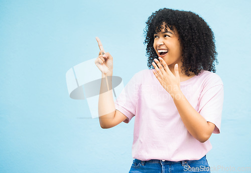 Image of Mock up, surprise or happy black woman point at sales promo, discount gift deal or marketing space gesture. Wow, product placement mockup or female advertising girl isolated on blue background studio