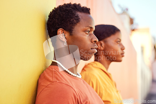 Image of Urban fashion, African people and couple of friends relax with designer brand clothes, casual style and luxury apparel. Gen z aesthetic, color and profile of black woman and man on orange yellow wall