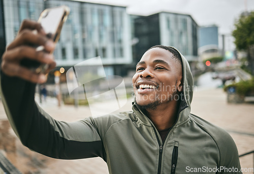 Image of Phone selfie, fitness and black man in city taking picture for social media or happy memory outdoors in winter. Sports, training and male runner with 5g mobile smartphone taking a photo on street.