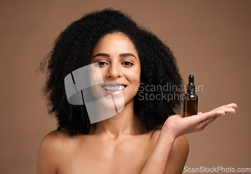 Image of Face portrait, skincare and black woman with bottle in studio isolated on a brown background. Makeup, cosmetics and female model holding hyaluronic acid, product or essential oil for facial treatment