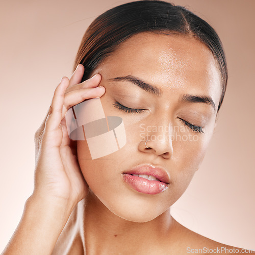 Image of Skincare, beauty and relax, woman with eyes closed, anti ageing acupressure and hand on face on studio background. Makeup, glamour and luxury skin care with hands on natural spa detox facial massage.