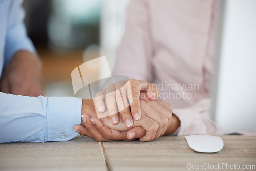 Image of Support, trust and couple holding hands in office for unity, union or comfort. Empathy, love or care of business people, man and woman together for teamwork, collaboration and solidarity in workplace