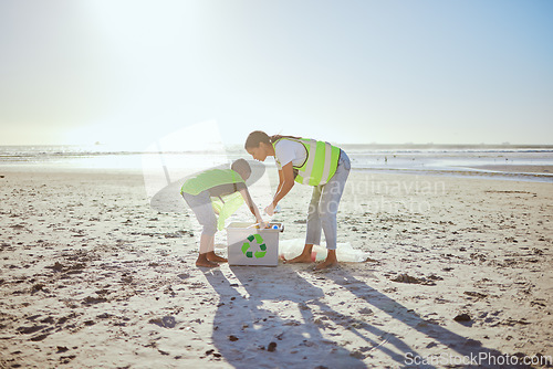 Image of Recycle, plastic and woman with child in beach cleaning support for sustainability, green environment or eco friendly ocean. Mother or volunteer family help with box at sea for pollution or earth day