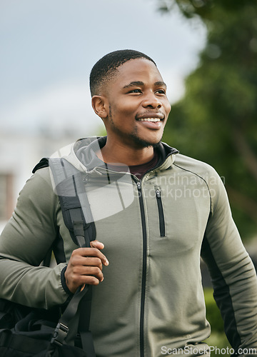 Image of Fitness, travel or happy black man walking to gym for training, exercise or workout with duffle bag in Atlanta. Pride, mindset or healthy sports athlete smiles with body goals, motivation or mission