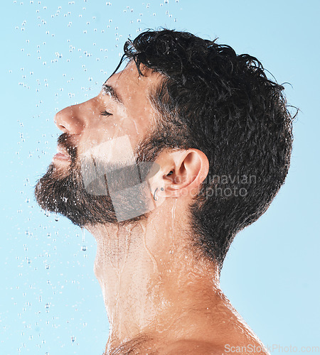 Image of Shower, man with water and face profile with cleaning and hygiene, grooming and skincare against blue studio background. Clean with water drops, facial with natural treatment and cosmetic mockup